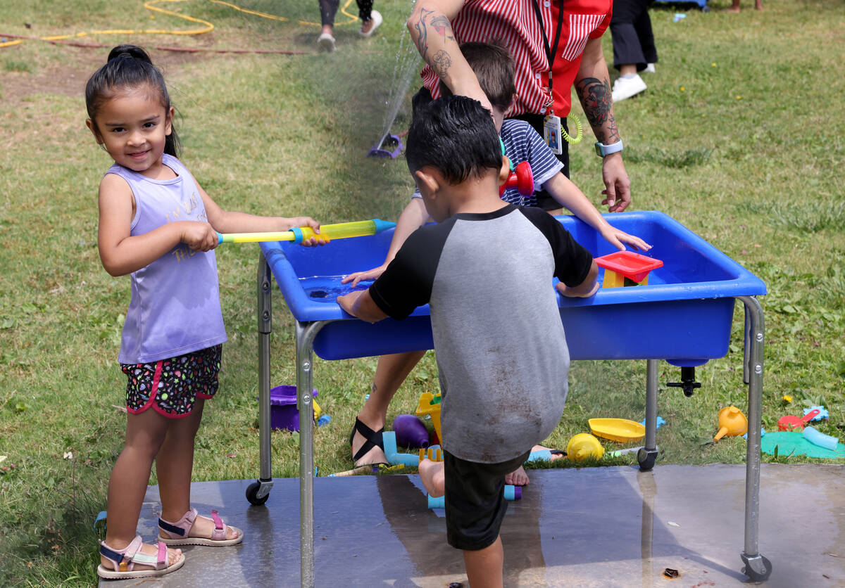 Pre-K student Gabriella Duyanen plays with water during the voluntary summer acceleration progr ...