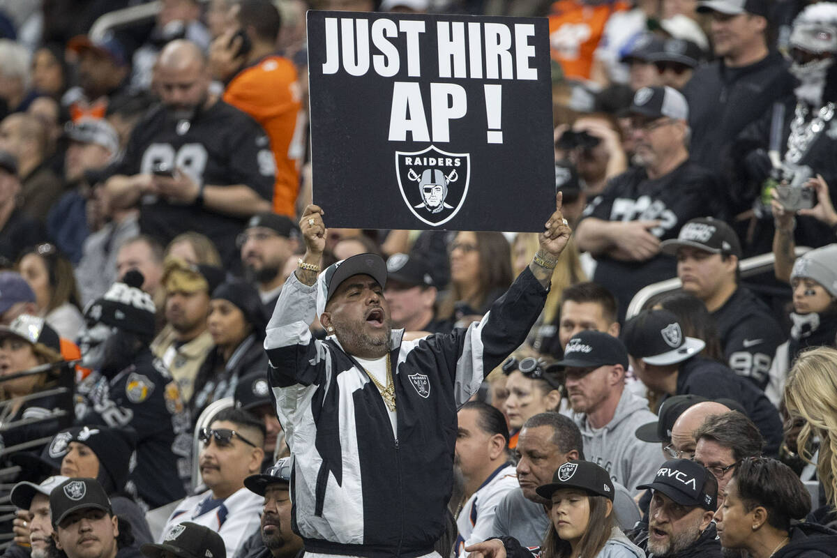 A fan holds up a sign in support of hiring Antonio Pierce as the Raiders head coach during the ...