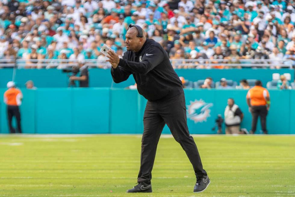 Raiders interim head coach Antonio Pierce applauds after an extra point is kicked during the fi ...