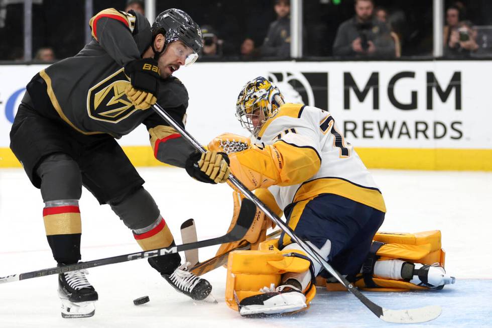 Vegas Golden Knights center Chandler Stephenson, left, attempts a goal while Nashville Predator ...