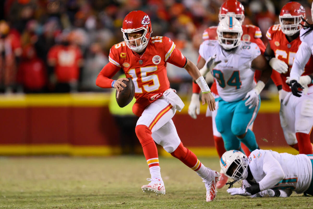 Kansas City Chiefs quarterback Patrick Mahomes escapes Miami Dolphins pressure and runs for a f ...