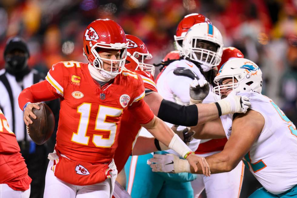 Kansas City Chiefs quarterback Patrick Mahomes (15) scrambles away from Miami Dolphins pressure ...