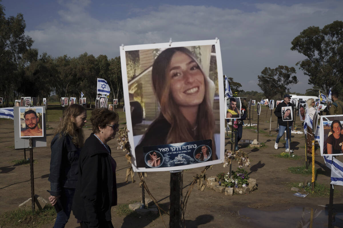 People visit the site where revelers were killed on Oct. 7 in a cross-border attack by Hamas at ...