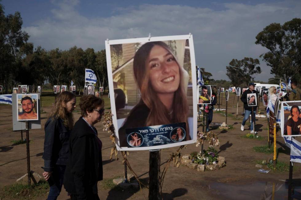 People visit the site where revelers were killed on Oct. 7 in a cross-border attack by Hamas at ...