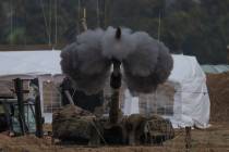 An Israeli mobile artillery unit fires a shell from southern Israel towards the Gaza Strip, in ...