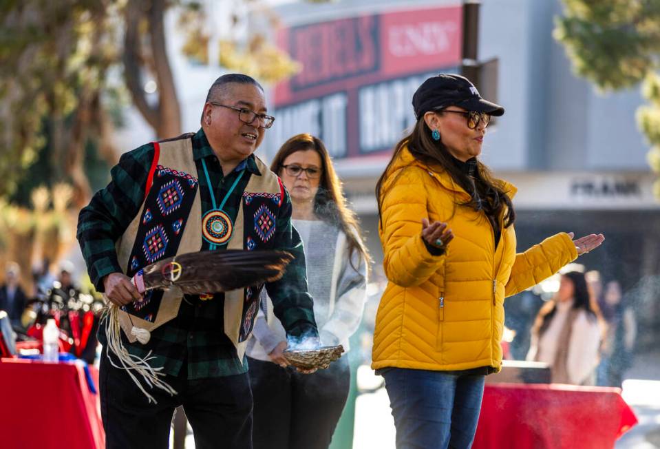Chris Spotted Eagle, spiritual leader for the Paiute Nation, performs smudging for attendees du ...