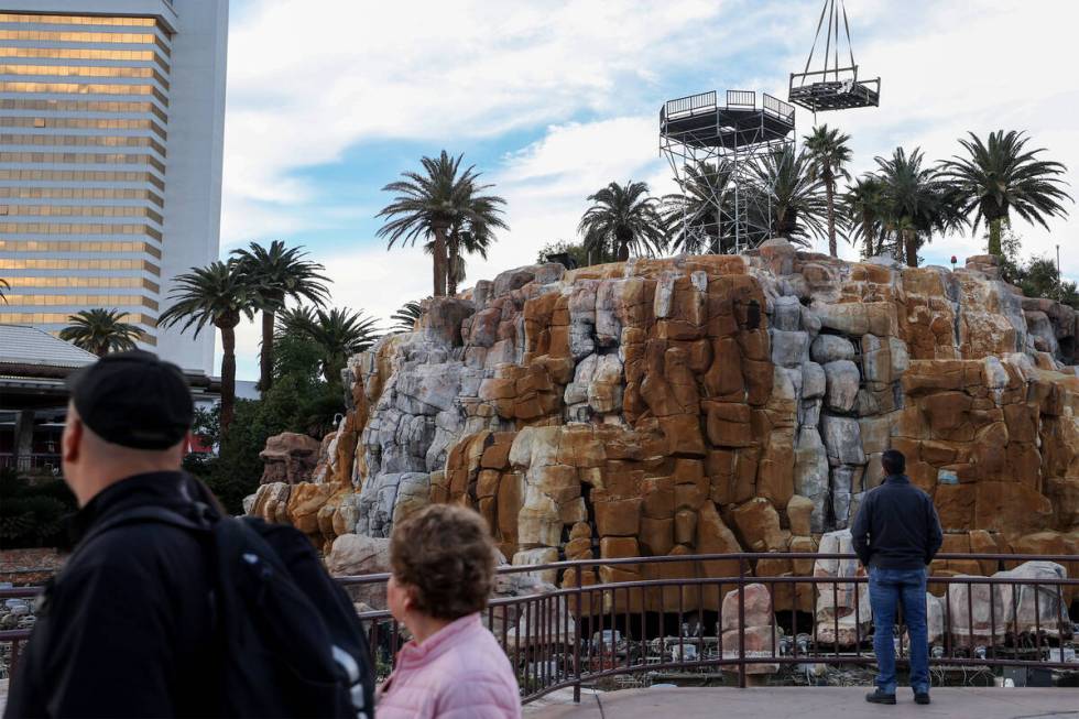 Passersby watch as construction is underway on the Mirage Volcano on Tuesday, Jan. 16, 2024, in ...