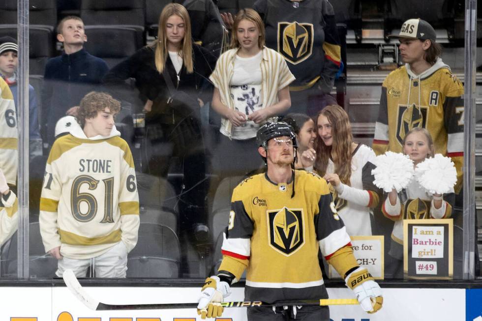 Golden Knights center Jack Eichel (9) warms up while fans giggle behind him before an NHL hocke ...