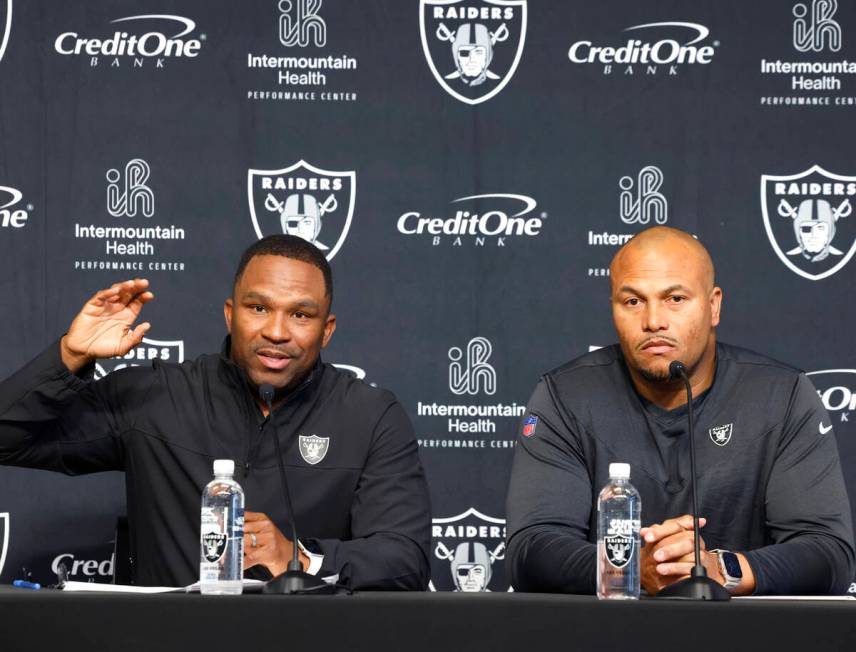 Champ Kelly, Raiders interim general manager, left, speaks during the press conference as Anton ...