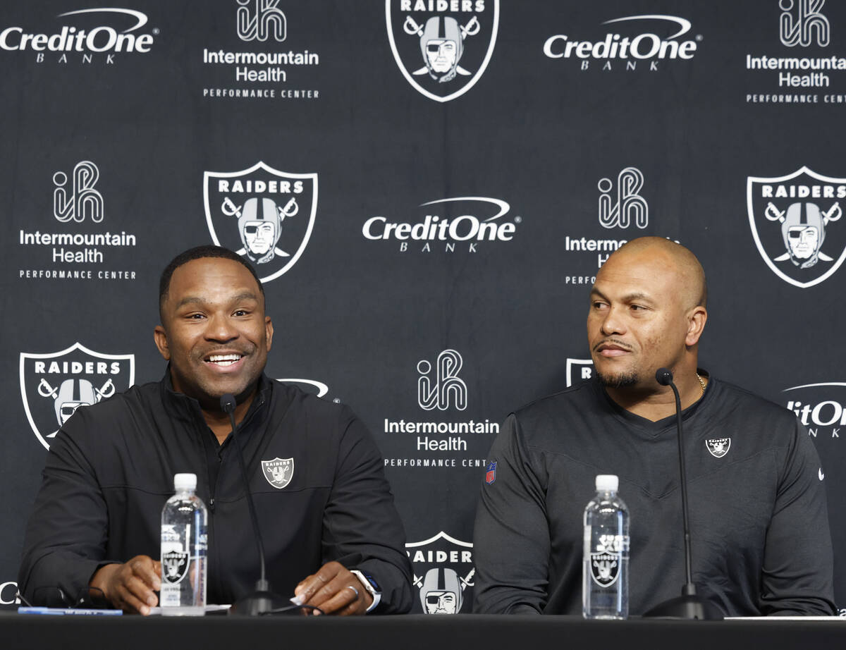 Champ Kelly, left, Raiders interim general manager, speaks during the press conference as Anton ...
