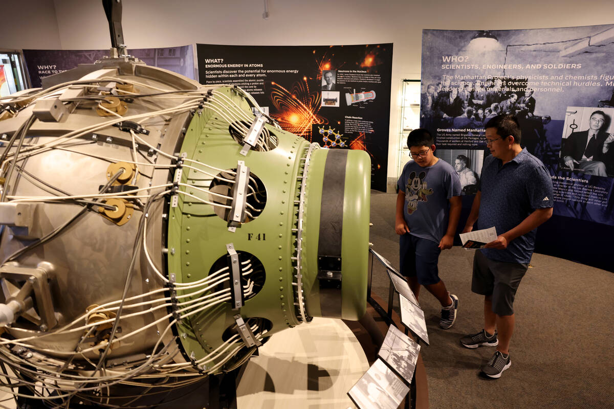 Dennis Heng, 12, and his father Chamroeun Heng check out a replica of Gadget and a display feat ...