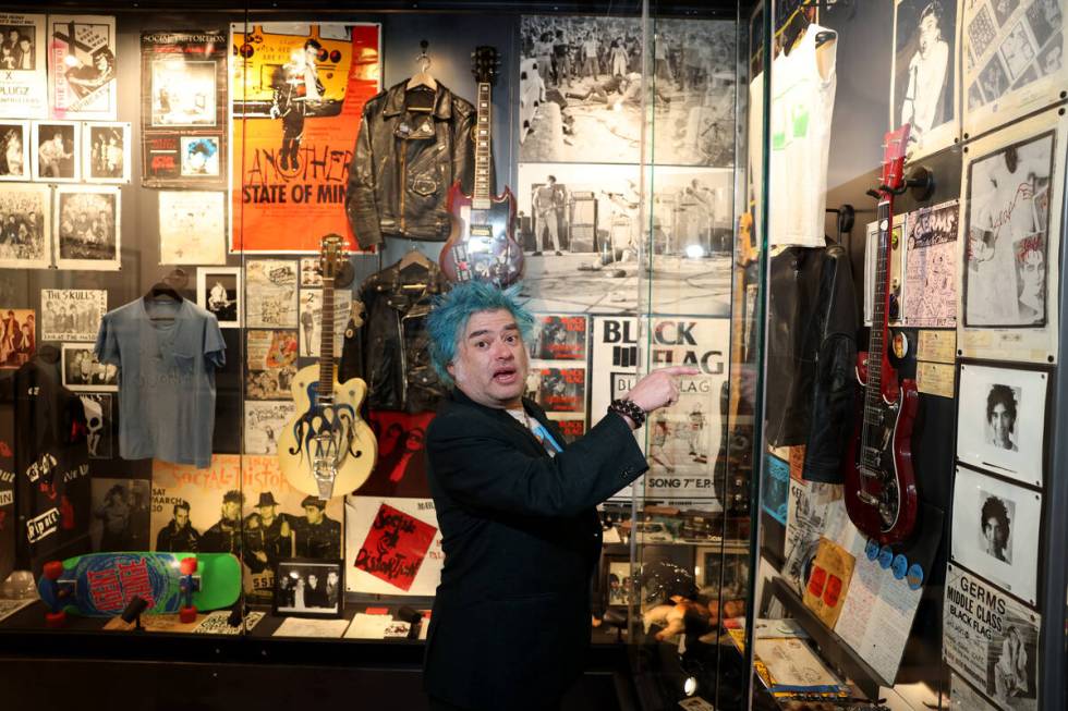 “Fat” Mike Burkett, co-founder of The Punk Rock Museum, shows Germs guitarist Pat ...