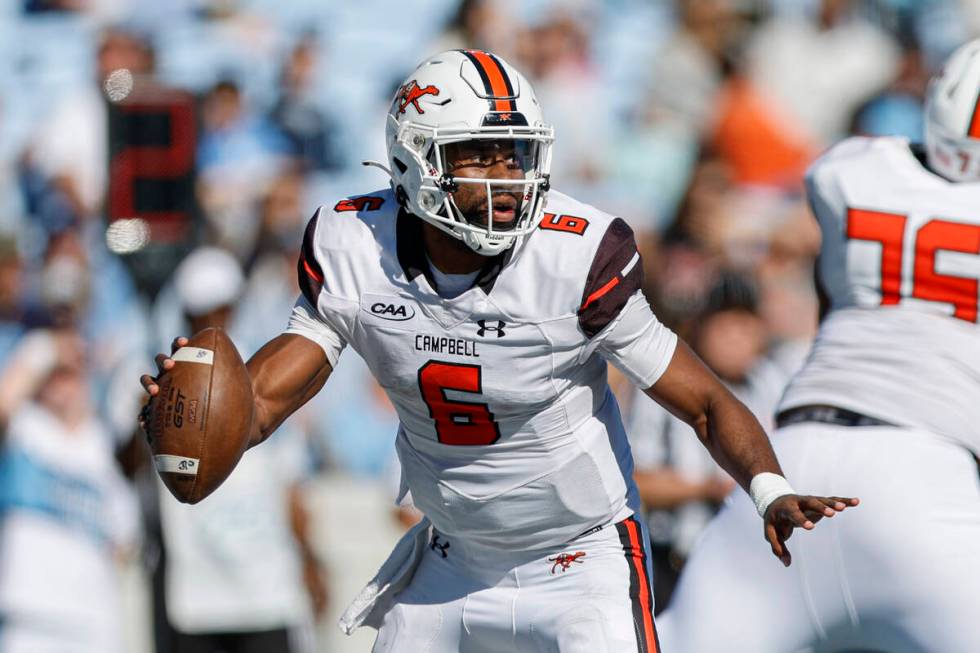 Campbell quarterback Hajj-Malik Williams scrambles in the second half of an NCAA college footba ...