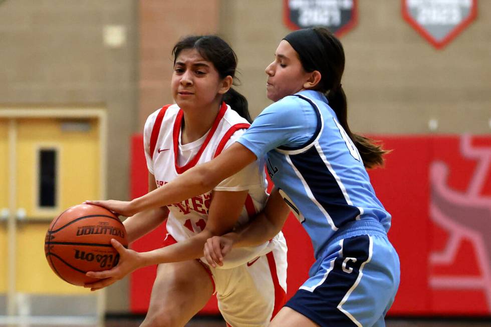 Arbor View's Arianna Vera (11) drives toward the hoop while Centennial's Bella Crawford (00) ge ...