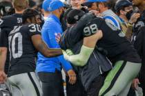 Raiders defensive end Maxx Crosby (98) hugs Raiders interim head coach Rich Bisaccia as Raiders ...