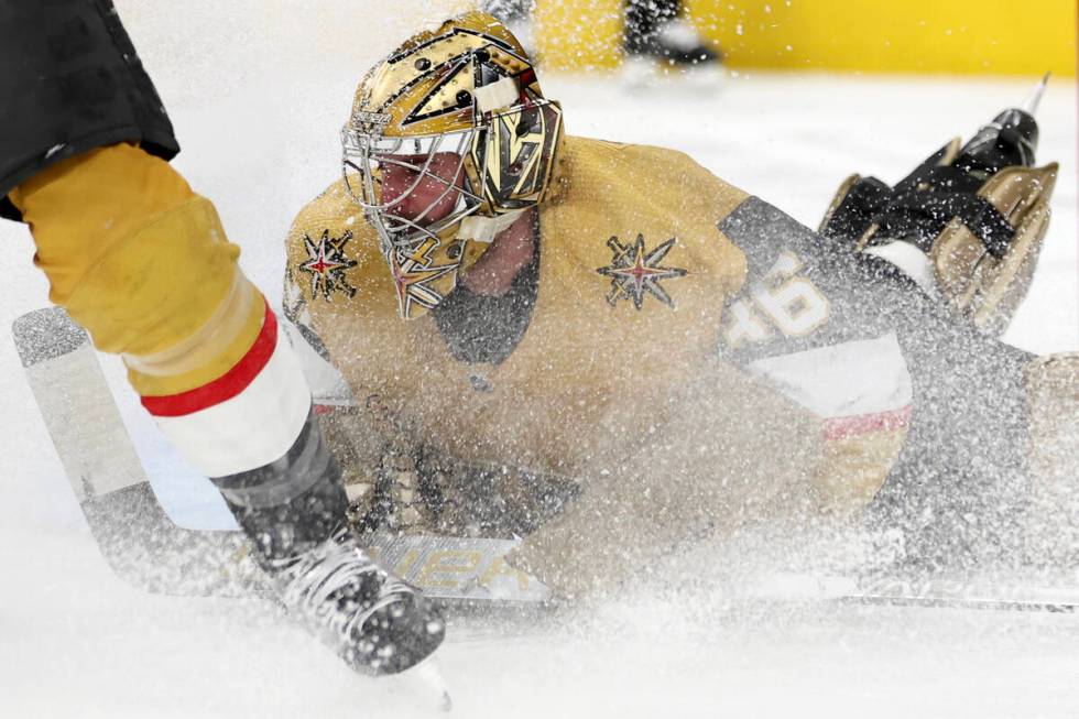 Golden Knights goaltender Logan Thompson (36) dives to save during the second period of an NHL ...