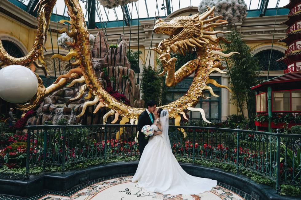 Jojo Keovilay, left, kisses his bride, Justine Keovilay, on the day of their wedding at a Chine ...