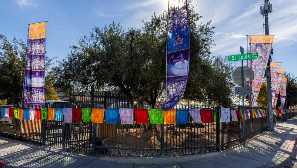 Prayer flags and banners line the outside fence during the opening ceremony of the Benevolence ...