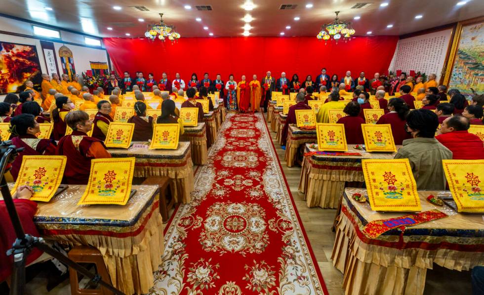 Holy Guru Zhengda Jiaozun, center, joins invited dignitaries in a ribbon cutting during the ope ...