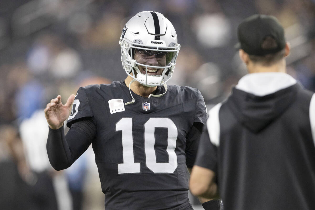 Raiders quarterback Jimmy Garoppolo (10) greets an assistant before an NFL game against the Los ...