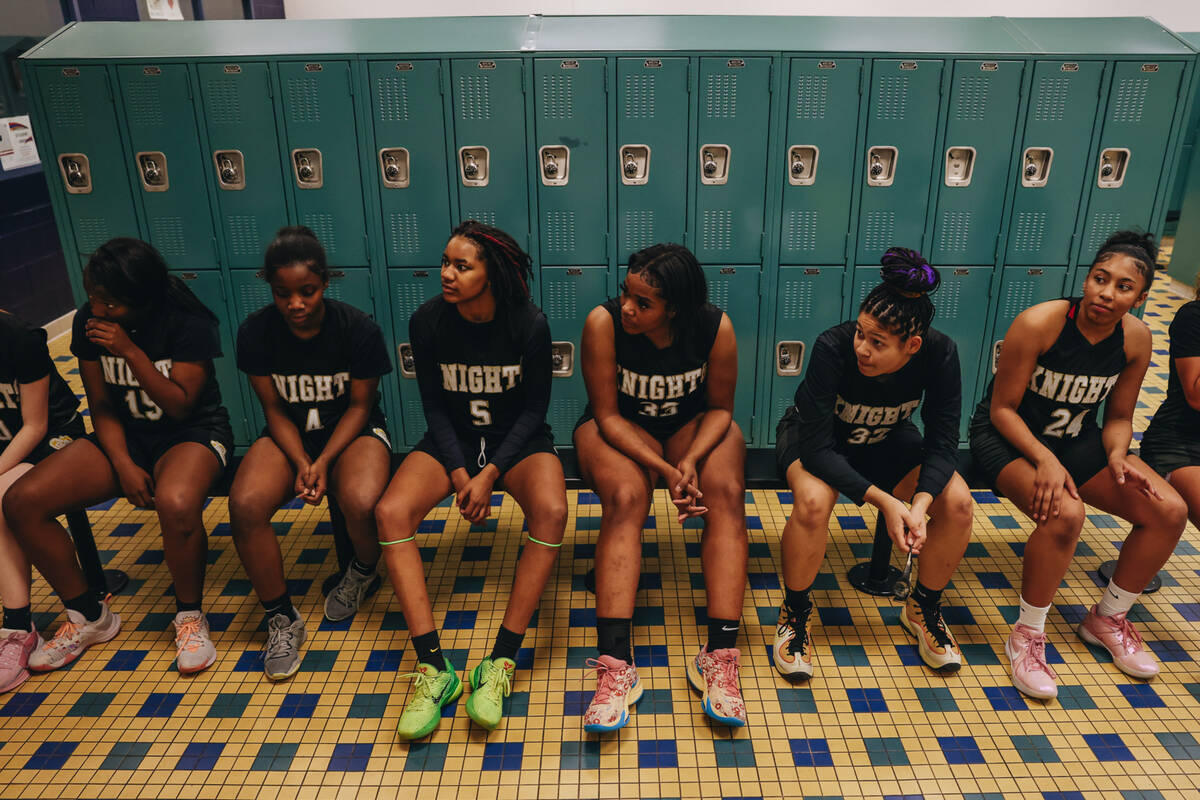 The Democracy Prep girls basketball team sits in the locker room during halftime of a game agai ...