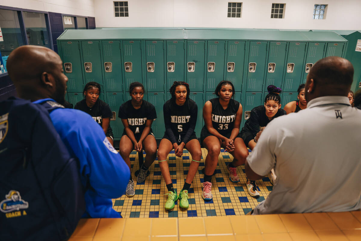 The Democracy Prep girls basketball team listen to speeches from their coaches in the locker ro ...