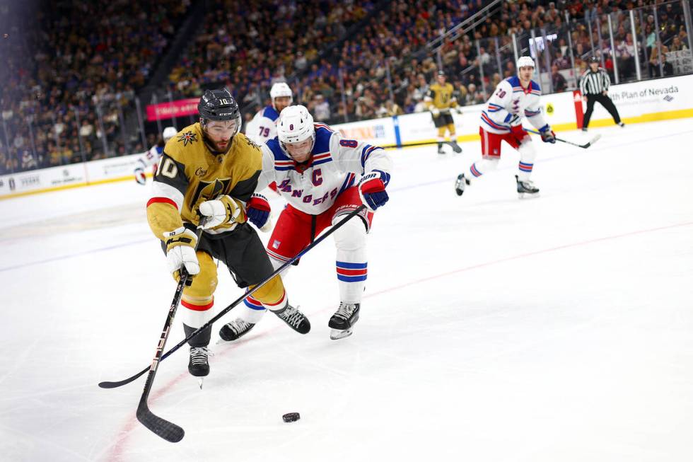 Golden Knights center Nicolas Roy (10) skates for the puck against Rangers defenseman Jacob Tro ...