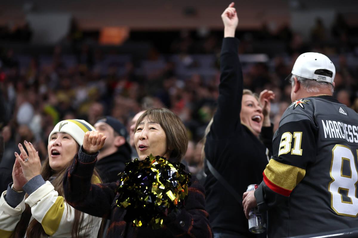 Golden Knights fans celebrate a goal during the first period of an NHL hockey game against the ...