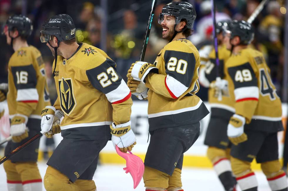 Golden Knights defenseman Alec Martinez (23) and center Chandler Stephenson (20) celebrate afte ...