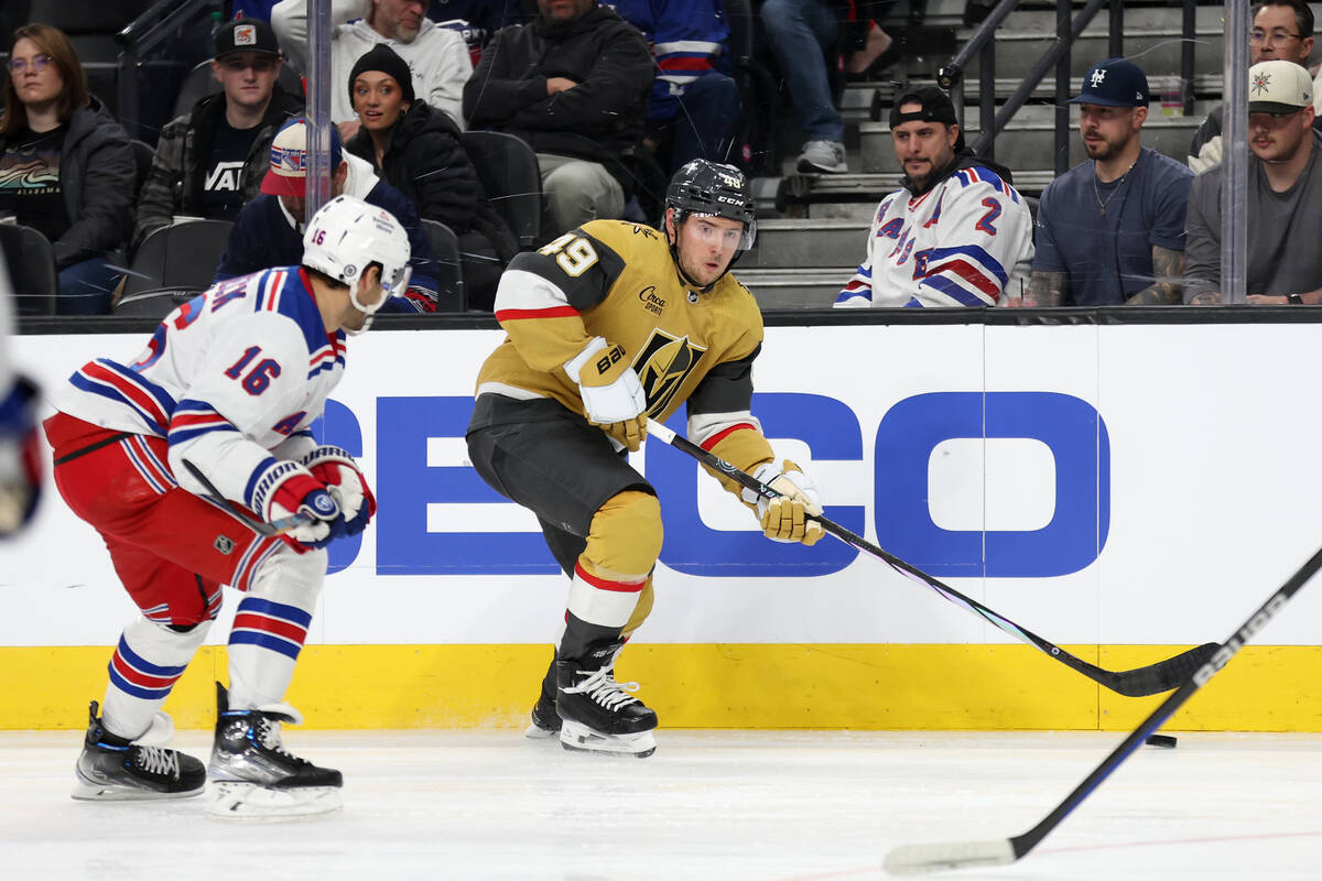 Golden Knights center Ivan Barbashev (49) looks to pass with pressure from Rangers center Vince ...