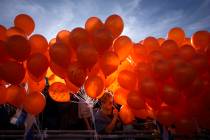 Demonstrators hold orange balloons at a rally in solidarity with Kfir Bibas, an Israeli boy who ...