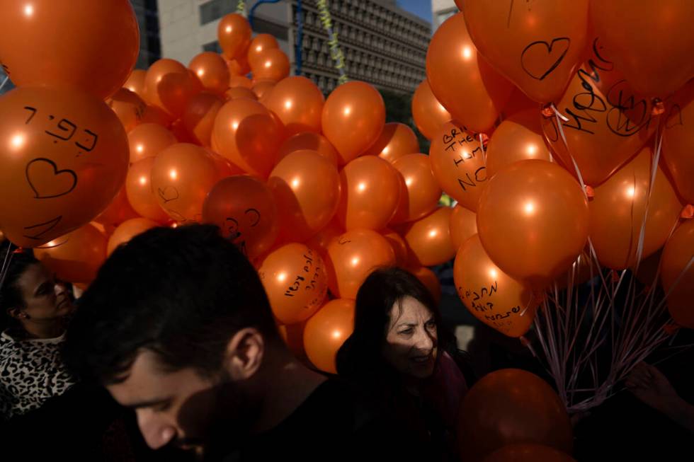 Demonstrators hold orange balloons at a rally in solidarity with Kfir Bibas, an Israeli boy who ...