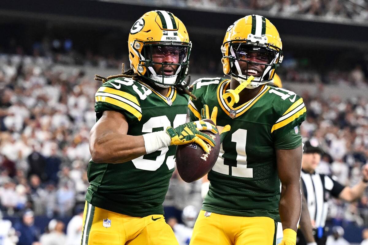 Green Bay Packers running back Aaron Jones (33) celebrates after his touchdown with wide receiv ...