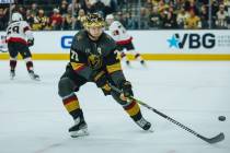 Golden Knights center William Karlsson (71) hits the puck across the ice during a game against ...