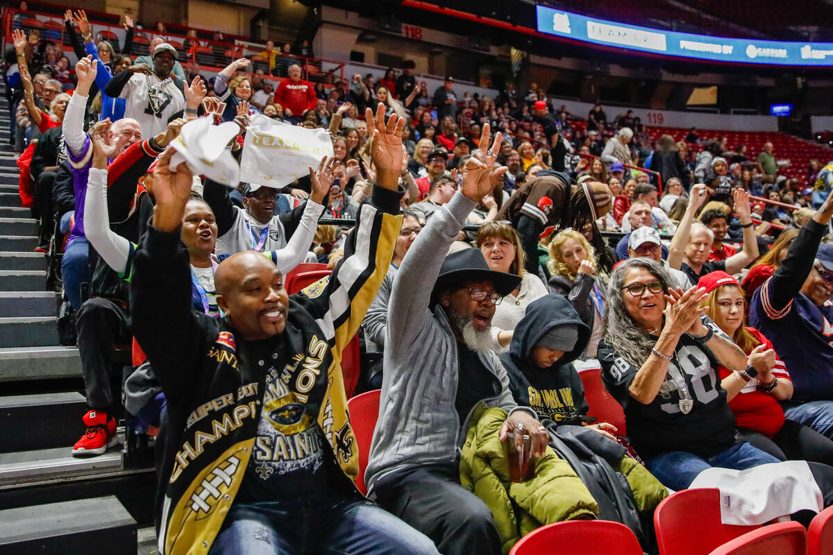 Marcus James, from left, Prentice Cole Jr., and Justine Haymes, all volunteers for Super Bowl L ...