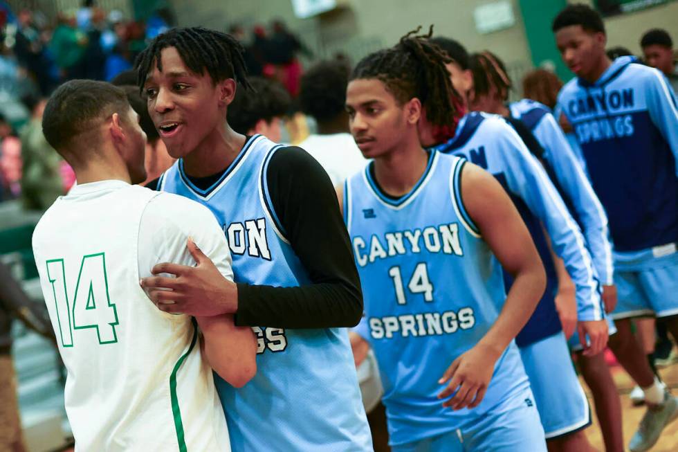 Canyon Springs guard Melvin Reece embraces Rancho guard Caleb Roston (14) after Rancho won thei ...