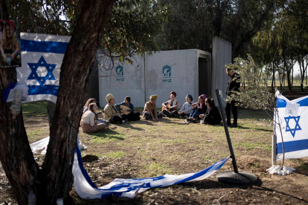 Jewish women sing together as they visit the site where hundreds of revelers were killed or cap ...