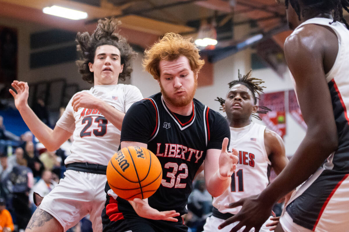 Liberty’s Ryder Bryan (32) attempts to rebound the ball during a basketball game between ...