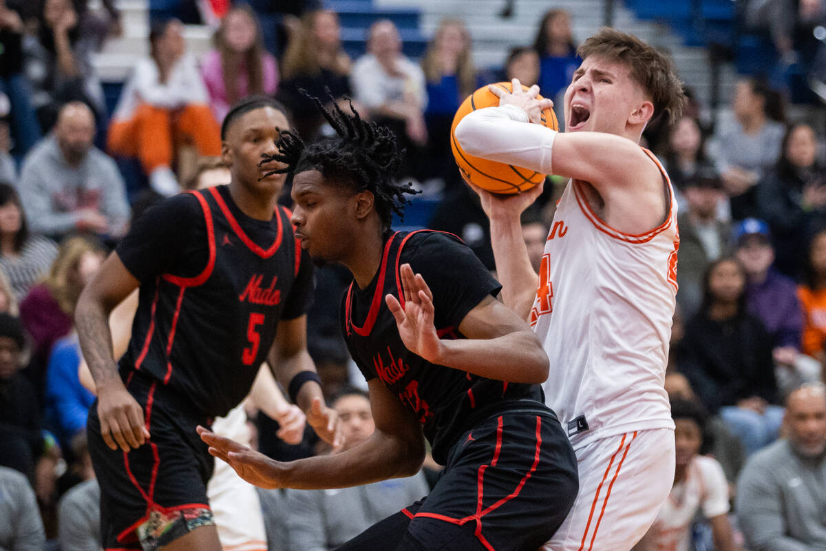 Bishop Gorman’s Ryder Elisaldez (24) shows grit as he rebounds the ball during a basketb ...