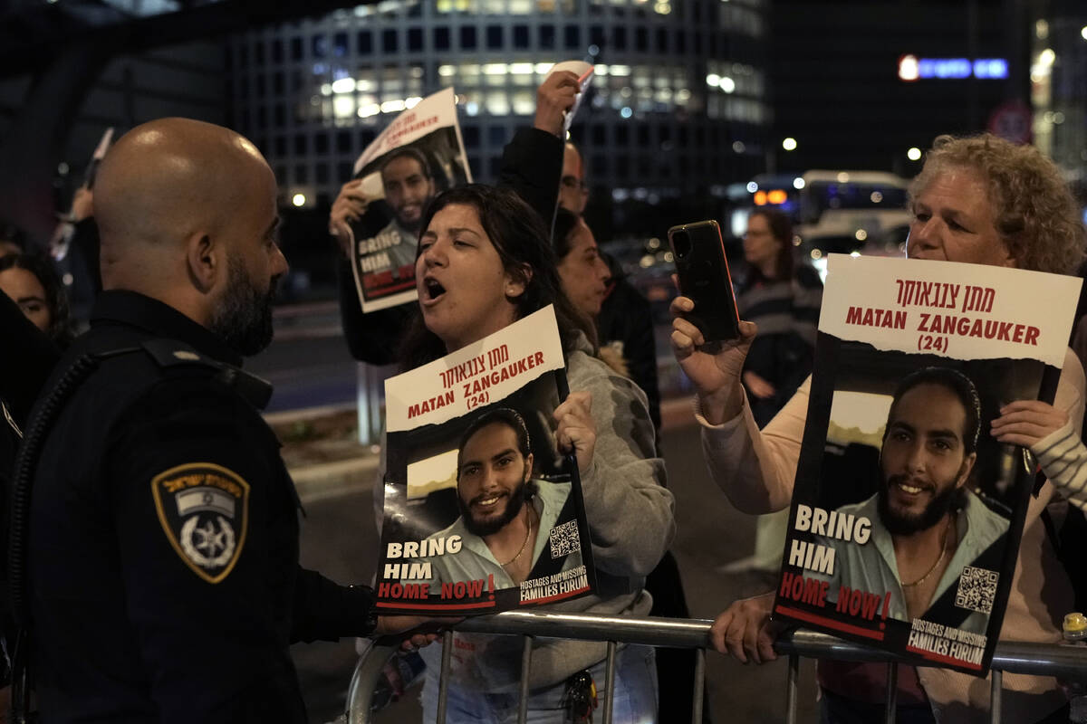 Protesters attempt to block a street during a demonstration to demand the release of the hostag ...