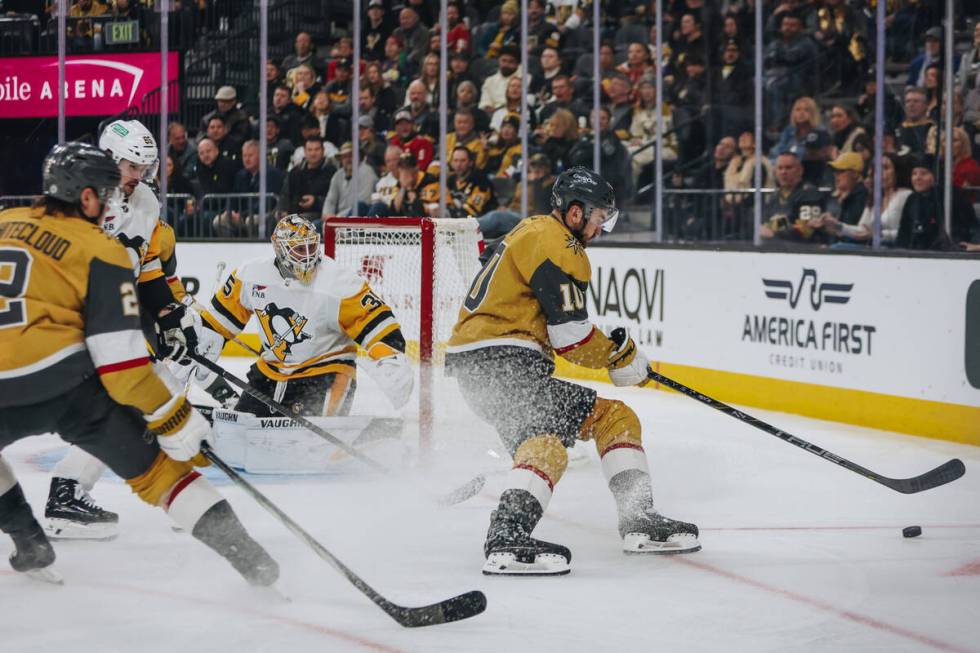 Golden Knights center Nicolas Roy (10) shuffles the puck during a game against the Pittsburgh P ...