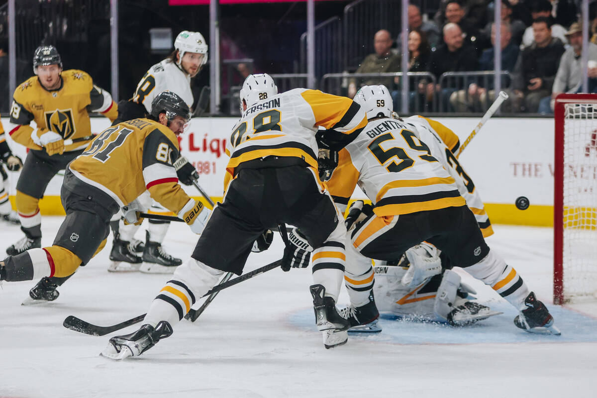 The puck flies into the net for a Golden Knights goal during a game against the Pittsburgh Peng ...