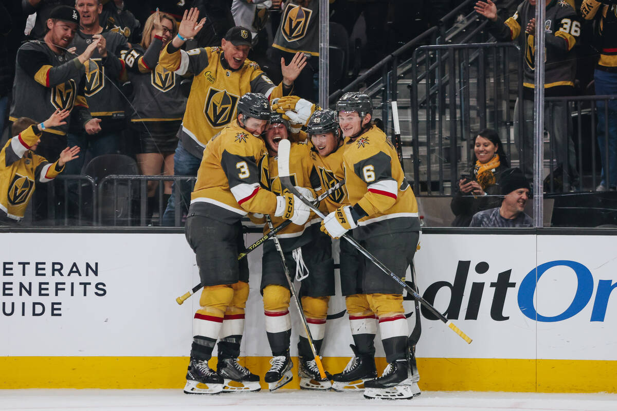 Golden Knights center Brendan Brisson (19) celebrates his first goal with his teammates during ...