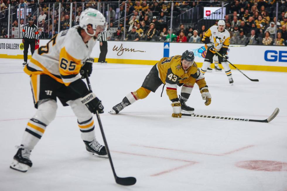 Golden Knights center Paul Cotter (43) watches Pittsburgh Penguins defenseman Erik Karlsson (65 ...