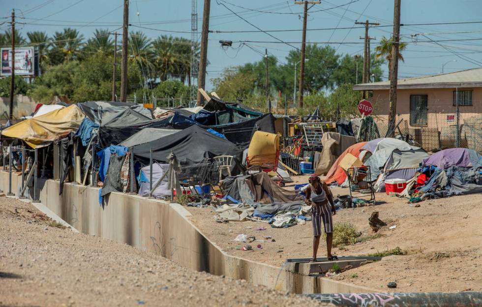 Homeless people begin their day as members of Food Not Bombs and the Sidewalk Project work to c ...