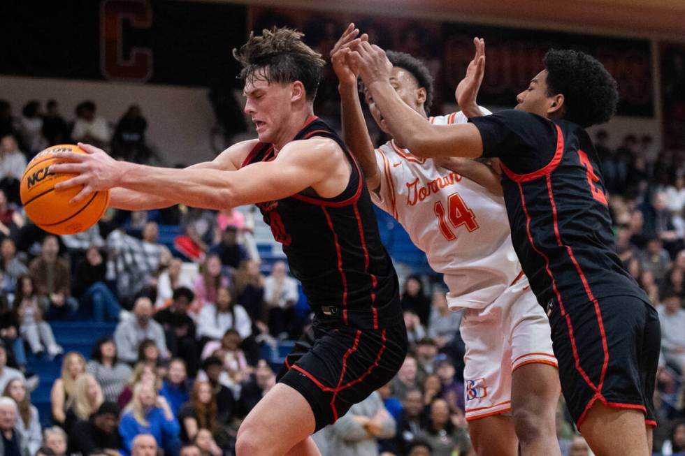 Coronado’s JJ Buchanan (10) rebounds the ball during a basketball game between Coronado ...