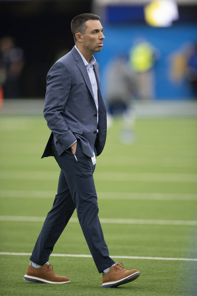 Los Angeles Chargers general manager Tom Telesco talks on the field before an NFL football game ...