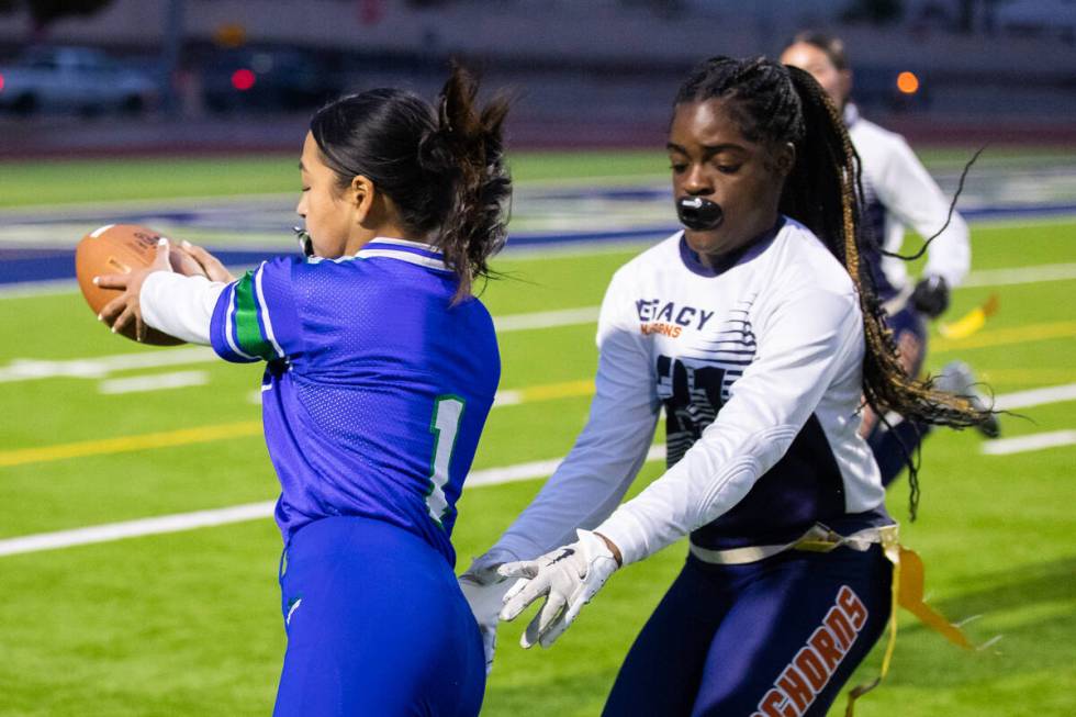 Legacy’s Olivia Hubbard (21) pulls the flag off of Green Valley’s Dianna Rincan ( ...