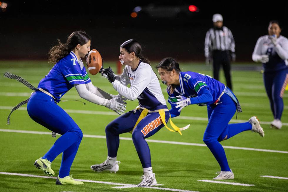 Legacy’s Larissa Lotta (5) attempts to run around Green Valley’s Lyla Baxter (7) ...