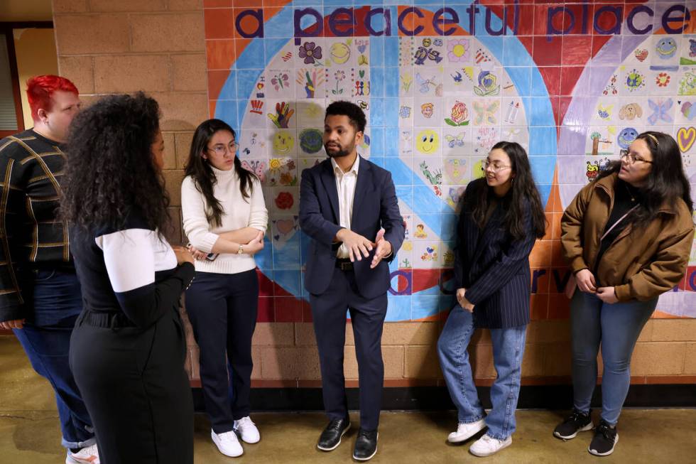 Rep. Maxwell Frost, D-Fla., fourth from left, talks with UNLV mass shooting survivors after a r ...